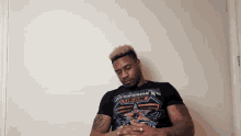 a man wearing a black t-shirt that says dean