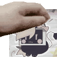 a close up of a person 's hand holding a piece of paper with a cat on it .