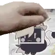 a close up of a person 's hand holding a piece of paper with a cat on it .