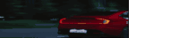 a red car is driving down a road at night with a license plate that says a2cw292 .