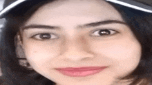a close up of a woman wearing a hat and smiling .