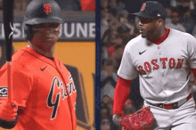 two baseball players one from the giants and one from the red sox