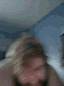a man with a beard laying on a bed