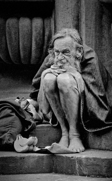 a man with a beard is sitting on a set of steps