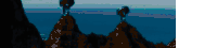 a blurry picture of a cliff overlooking a body of water .