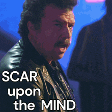 a man in a leather jacket with the words scar upon the mind written below him