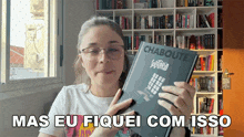 a woman is holding a book by chaboute and says " mas eu fiquei com isso "