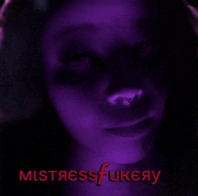 a close up of a woman 's face with the words mistressfukeay written in pink