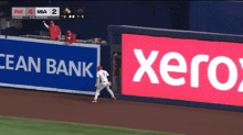 a baseball game is being played in front of a xerox advertisement