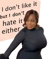 a woman stands in front of a sign that says i don 't like it