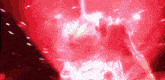 a red background with a glowing object in the middle of it