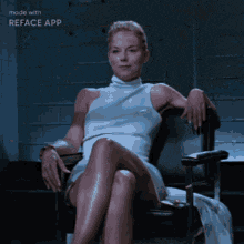 a woman in a white dress is sitting in a chair with her legs crossed ..