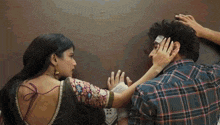a man with a bandage on his head is being held by a woman