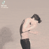 a tiktok video of a shirtless man with a cigarette in his mouth