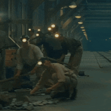 a group of men wearing hard hats are working on a construction site