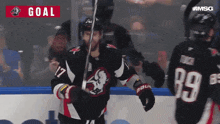 a hockey player with the number 17 on his jersey holds a hockey stick