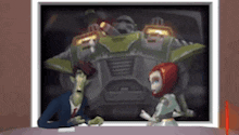a man and a robot are sitting at a table in front of a large robot .
