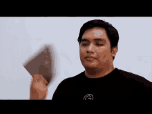 a man wearing a black shirt with a circle on it