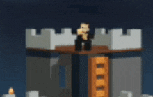 a lego figure is standing on top of a castle tower .