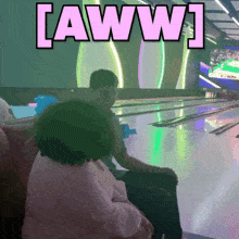 a bowling alley with the words [ aww ] on the screen