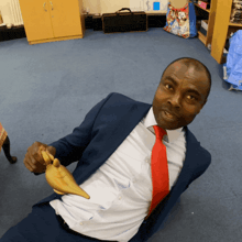 a man in a suit and tie is holding a lamp in his hand