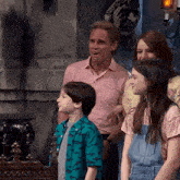 a group of people standing in front of a statue of a skull