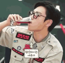 a man in a big bang uniform drinks a glass of wine