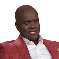 a man wearing a red jacket and white shirt is smiling with his eyes closed