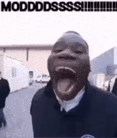 a man is making a funny face with his mouth open and his tongue hanging out .