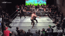 a jcw wrestling match is being shown on a screen