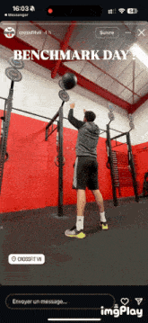 a man is doing a benchmark day exercise with a ball
