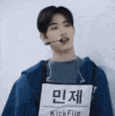 a young man wearing a microphone and a name tag that says kickflip on it .