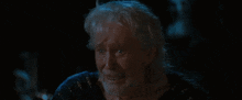 a man with gray hair and a beard is making a funny face
