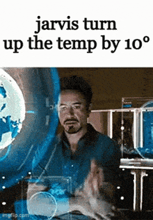 a man is sitting in front of a screen with the words jarvis turn up the temp by 10 degrees on it .