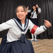 a girl in a sailor uniform has the letter a on her arm band
