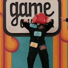a person standing in front of a sign that says " game "