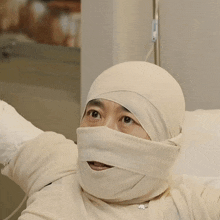 a person with a bandage on their head looks at the camera