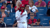 a baseball player for the nationals is standing in front of a crowd