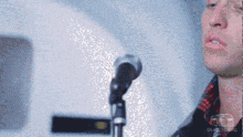 a pixelated image of a man singing into a microphone with fox on the bottom