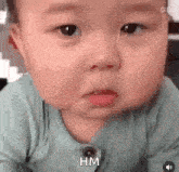 a baby is making a funny face with his mouth open and his eyes closed .
