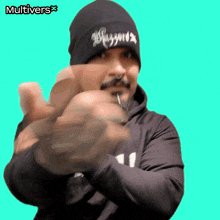 a man wearing a beanie that says blizzards is pointing at the camera