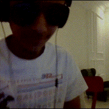 a man wearing headphones and sunglasses is wearing a white shirt that says hawaii
