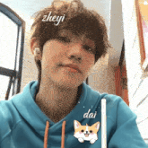 a boy wearing a blue hoodie with the name zheyi on it