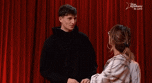 a group of people are dancing in front of a red curtain that says star academy