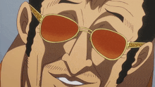 a close up of a man wearing sunglasses with a gold frame