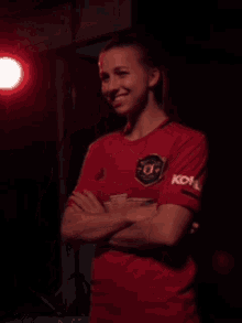 a woman wearing a red shirt that says royal on the sleeve
