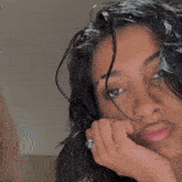 a woman with a nose ring looks at the camera