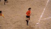 a group of soccer players are playing on a field and one of them is wearing a red shirt