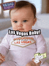 a baby is wearing a las vegas shirt and has a 100 dollar bill on her wrist