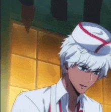 a man with white hair is wearing a white hat with a red stripe on it .